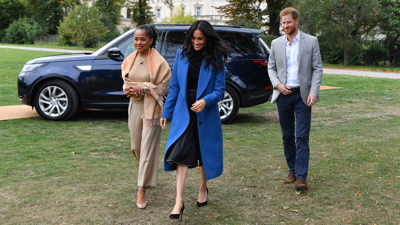 Meghan, Duchess of Sussex (C) arrives with her mother Doria Ragland (L) and Prince Harry, Duke of Sussex to host an event to mark the launch of a cookbook with recipes from a group of women affected by the Grenfell Tower fire on Sept. 20, 2018 in London, England.